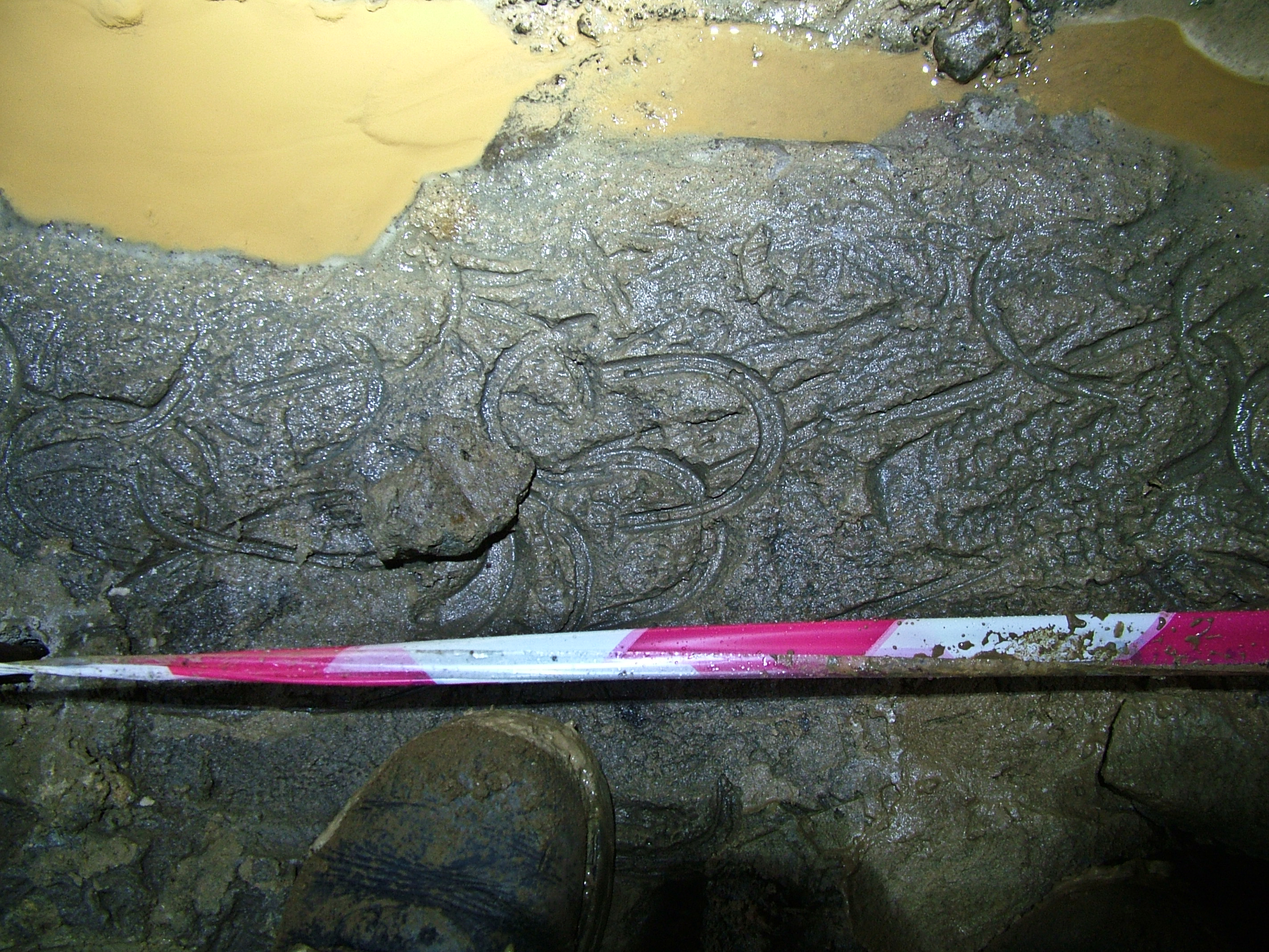 Old miners clog prints in a cross cut above the adit